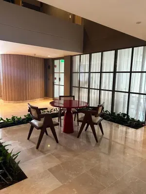 a table and chairs in a room with windows at Apartamento de lujo para estrenar en Morros Cartagena in Cartagena de Indias