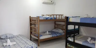 a room with three bunk beds and a bed at Casa Campestre Valle del Mar in Santa Marta