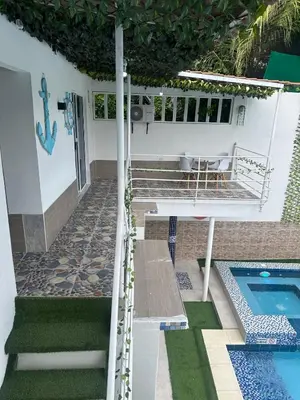 a patio with a swimming pool and a house at Casa Campestre Valle del Mar in Santa Marta
