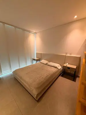 a bedroom with a bed and a side table at District Aptosuite 404 in Barranquilla