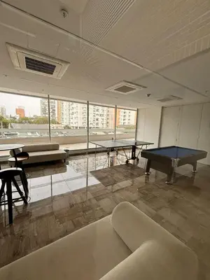 a room with a ping pong table and a couch at District Aptosuite 404 in Barranquilla