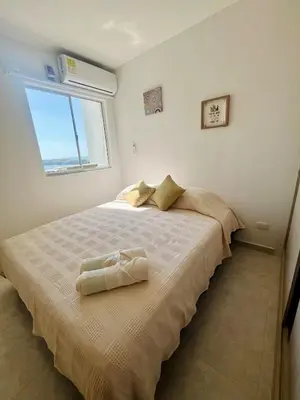 a bedroom with a large bed with a window at Beautiful view in Cartagena in Cartagena de Indias