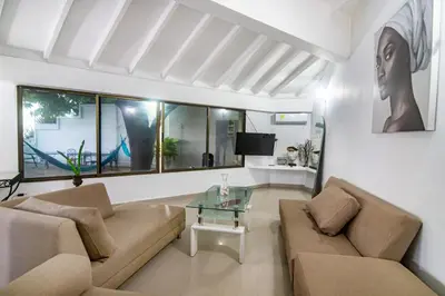 a living room with a couch and a glass table at Casa de playa vistamare in Santa Marta