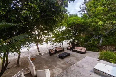 a group of chairs and tables on the beach at Casa de playa vistamare in Santa Marta