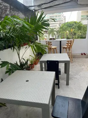 a patio with two tables and chairs and plants at Habitación cerca de la playa 203 in Cartagena de Indias