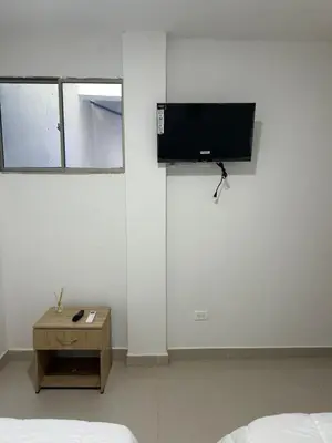 a bedroom with a bed and a tv on the wall at Casa ayola in Cartagena de Indias