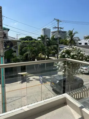 a balcony with a view of a street with a car at Casa ayola in Cartagena de Indias