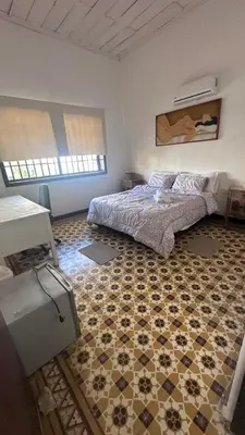 a bedroom with a bed and a tiled floor at Apartamento de la A samblea in Cartagena de Indias