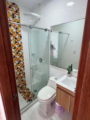 a bathroom with a shower and a toilet and a sink at Encantador Apartamento El Laguito Bocagrande in Cartagena de Indias