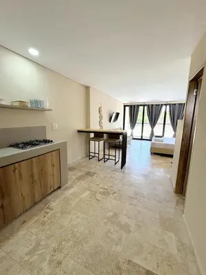 a kitchen and living room with a counter and a table at Apartment in Coveñas FOREST in Coveñas