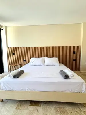 a large bed with two pillows on top of it at Apartment in Coveñas FOREST in Coveñas