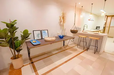 a kitchen with a table and stools in a room at Modern and cozy Beachfront house Santa Marta 7pax in Simón Bolívar International Airport