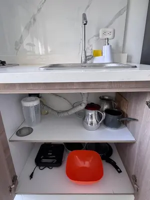 a kitchen cabinet with a sink and a shelf at Apartmento en Ciudad Mallorquín in Puerto Colombia