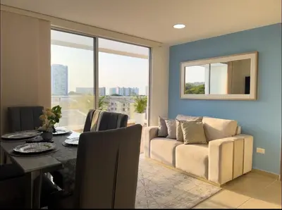 a living room with a couch and a table at Apartment with large balcony in Cartagena de Indias