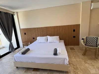 a bedroom with a bed with towels on it at Forest Condominio in Coveñas