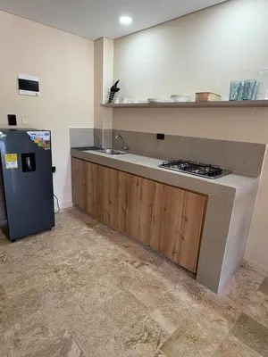 a kitchen with a sink and a refrigerator at Forest Condominio in Coveñas