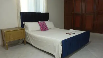 a bed in a room with a phone on it at Prado alto inn in Barranquilla