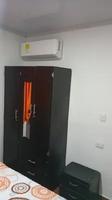 a bedroom with a black cabinet and a air conditioner at Apartamento #4 in Puerto Colombia