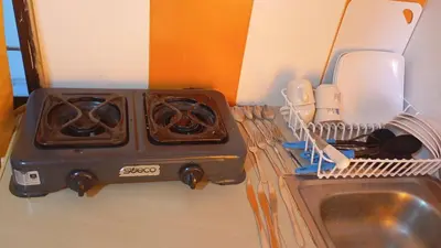 a stove top oven sitting on a counter next to a sink at Apartamento #5 in Puerto Colombia