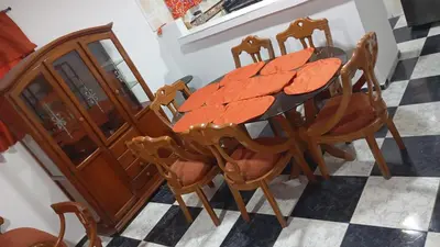 a dining room table with chairs and a wooden cabinet at Apartamento #6 in Puerto Colombia