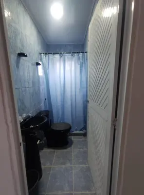 a small bathroom with a toilet and a sink at Apartamento #6 in Puerto Colombia