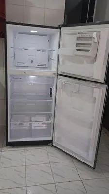 an empty refrigerator with its door open in a kitchen at Apartamento #7 in Puerto Colombia