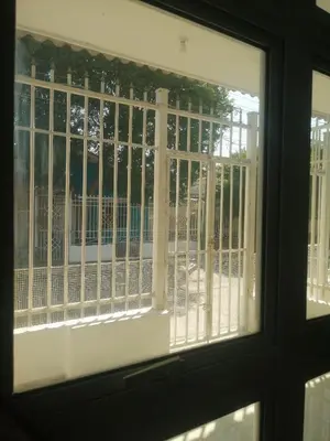 a window with a view of a balcony with white bars at Rey Salomón in Barranquilla