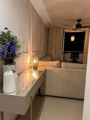 a living room with a couch and a table with flowers at the best view of Barranquilla in Barranquilla