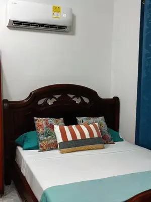 a bed with two pillows on it with avertisement at Art House Getsemaní in Cartagena de Indias