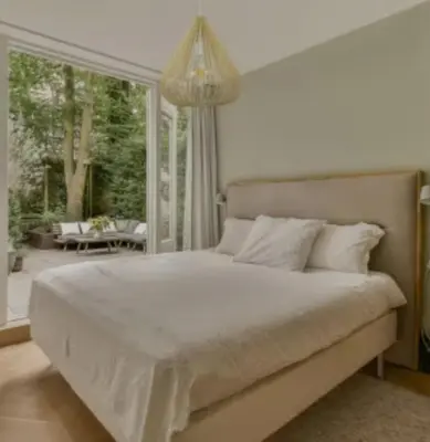 a bedroom with a large bed and a large window at Hotel El Confort in San Juan Nepomuceno