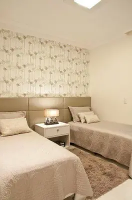 a bedroom with two beds and a table with a lamp at Hotel El Confort in San Juan Nepomuceno