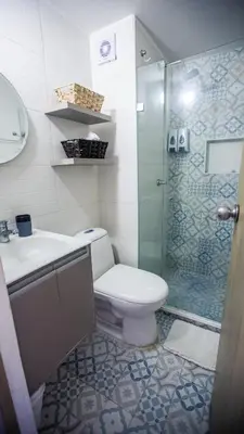 a bathroom with a toilet and a glass shower at Apartamento Oasis Cartagena in Cartagena de Indias