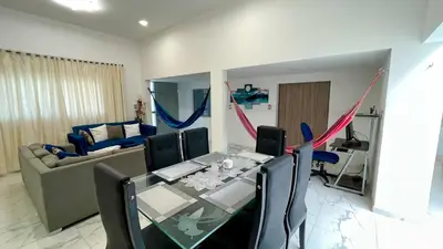 a living room with a table and a couch at Casa Elena in Tolú