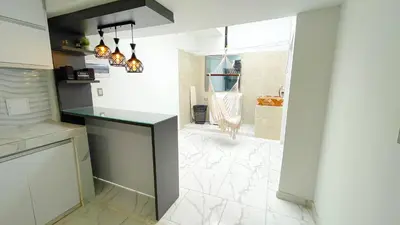 a kitchen with a counter and a bathroom with a shower at Casa Elena in Tolú