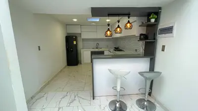 a kitchen with a counter and two stools at Casa Elena in Tolú