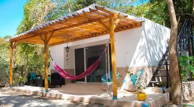a patio with a hammock in front of a house at Cabaña Mary Mar en Isla in Cartagena in Isla de Tierra Bomba