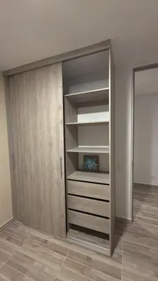 a closet with wooden doors in a room at Margarita's apt in Barranquilla