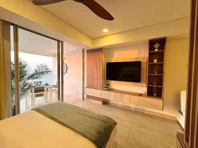 a bedroom with a flat screen tv and a bed at CB1108 | Sunset Suite con Frente al Mar in Cartagena de Indias