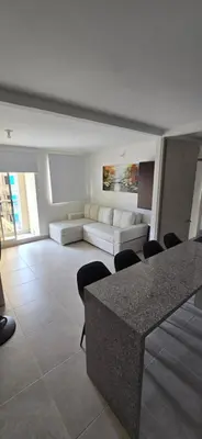 a living room with a white couch and a table at SERENA REST Conjunto Capriella Cartagena in Manzanillo del Mar