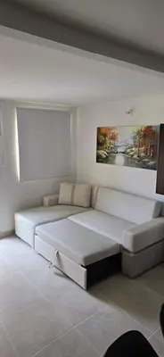 a large white couch in a room with a painting at SERENA REST Conjunto Capriella Cartagena in Manzanillo del Mar