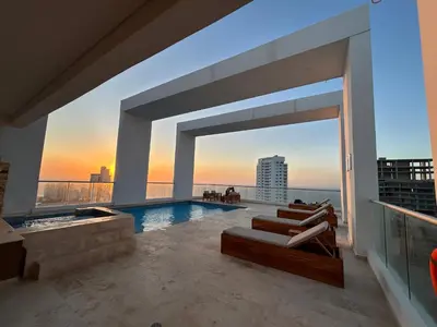 a house with a pool and a view of the ocean at APARTAMENTO MAGNO LOFT Bocagrande in Cartagena de Indias