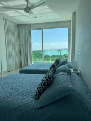a bedroom with two beds and a large window at Morros 922 Seaside Retreat in Cartagena de Indias