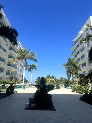 a courtyard with palm trees and a large building at Morros 922 Seaside Retreat in Cartagena de Indias