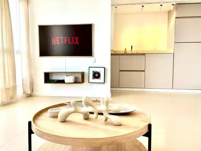 a living room with a table and a tv at Splendid condo with a sea view in Puerto Colombia