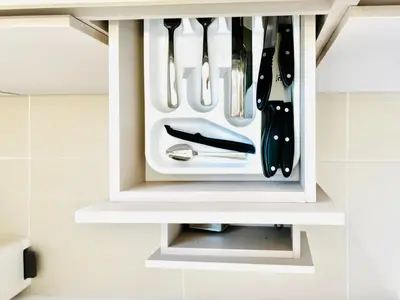 a white knife holder with utensils in it at Splendid condo with a sea view in Puerto Colombia