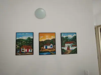 four paintings hanging on a wall at Apartamento Cartagena exclusive in Cartagena de Indias