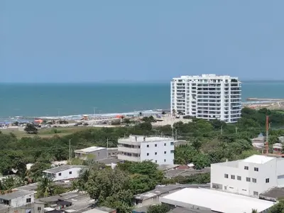 a large white building in front of the ocean at Apartamento Cartagena exclusive in Cartagena de Indias