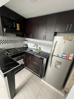 a kitchen with a stainless steel refrigerator and a sink at ruiseñor 1 in Barranquilla