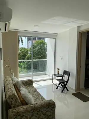 a living room with a couch and a chair at 1 bedroom apartment close to the beach in Cartagena de Indias