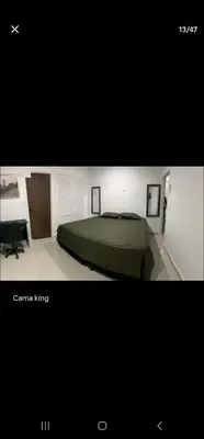 a picture of a bedroom with a bed and a desk at Marinares apartamento in Cartagena de Indias